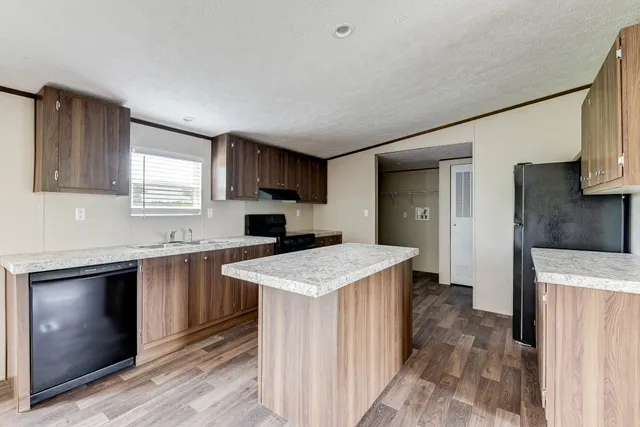 a kitchen with a sink stove and refrigerator