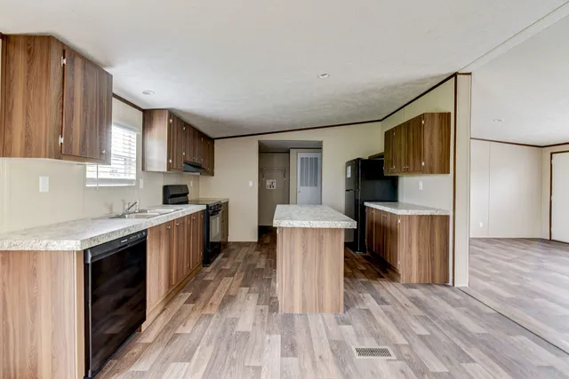 a kitchen with a sink stove top oven and cabinets