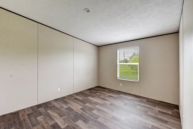 an empty room with a empty space and windows