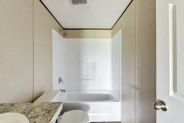 a bathroom with a tub and shower
