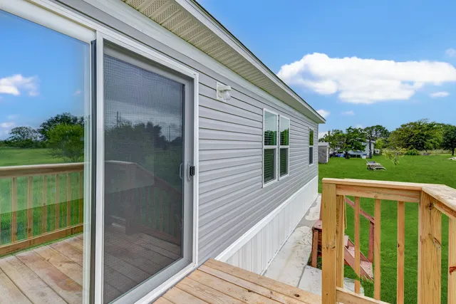 a view of a balcony with a floor to ceiling window and wooden floor