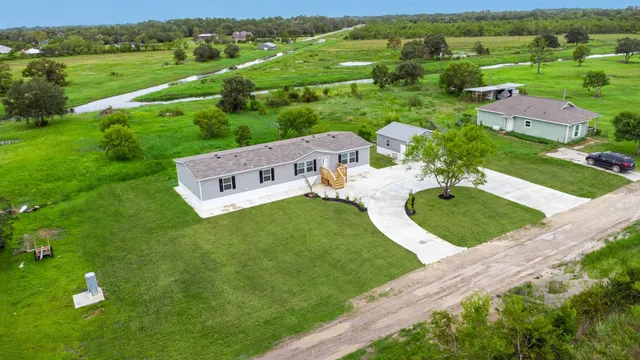 an aerial view of a house with yard
