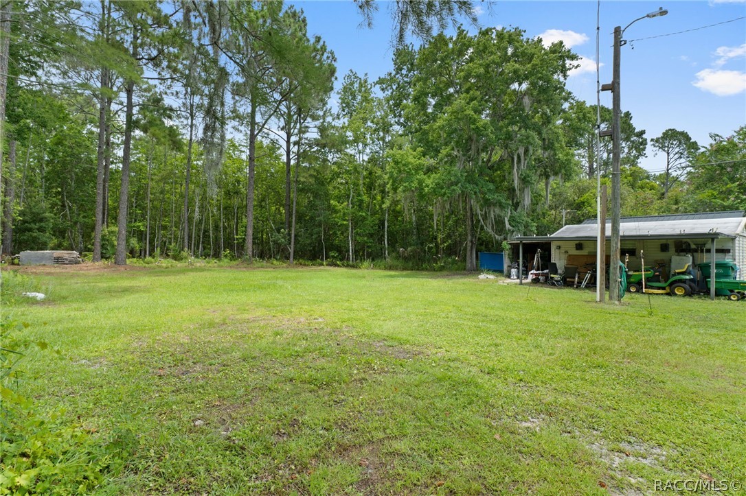 7927 West Cyprian Court Homosassa, FL 34448 - Photo 34 of 40 a view of outdoor space with deck and yard