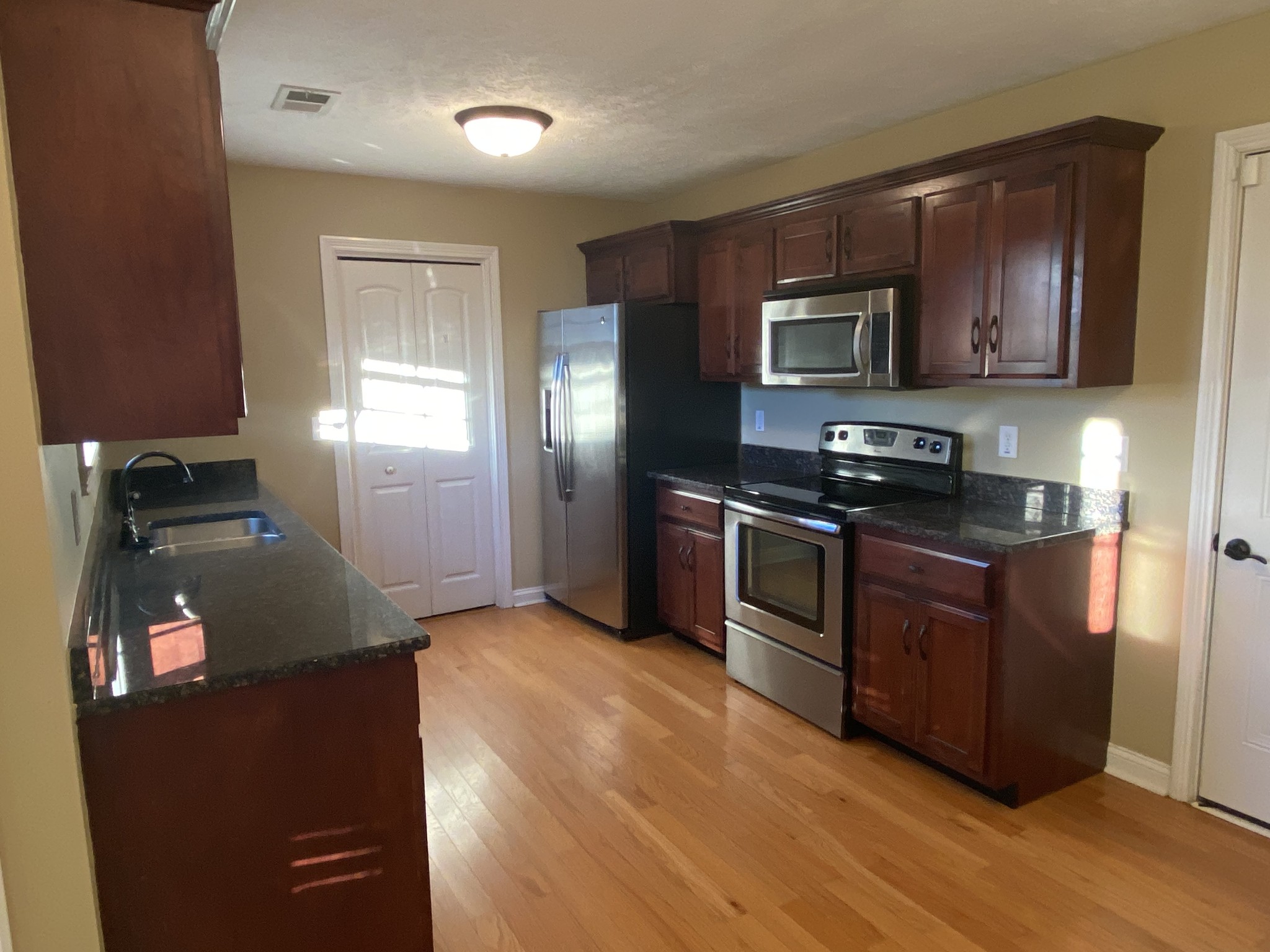3732 Suiter Road Clarksville, TN 37040 - Photo 6 of 14 a kitchen with stainless steel appliances granite countertop a stove a sink and a refrigerator