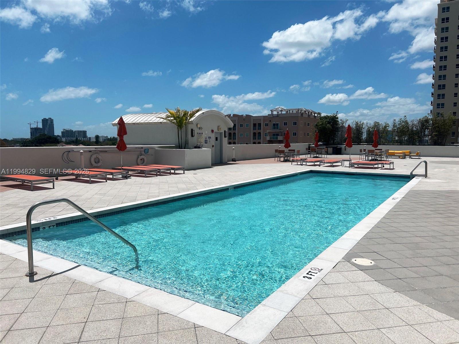3180 Southwest 22nd Terrace, Unit 607 Miami, FL 33145 - Photo 5 of 18 a view of a swimming pool and lounge chairs