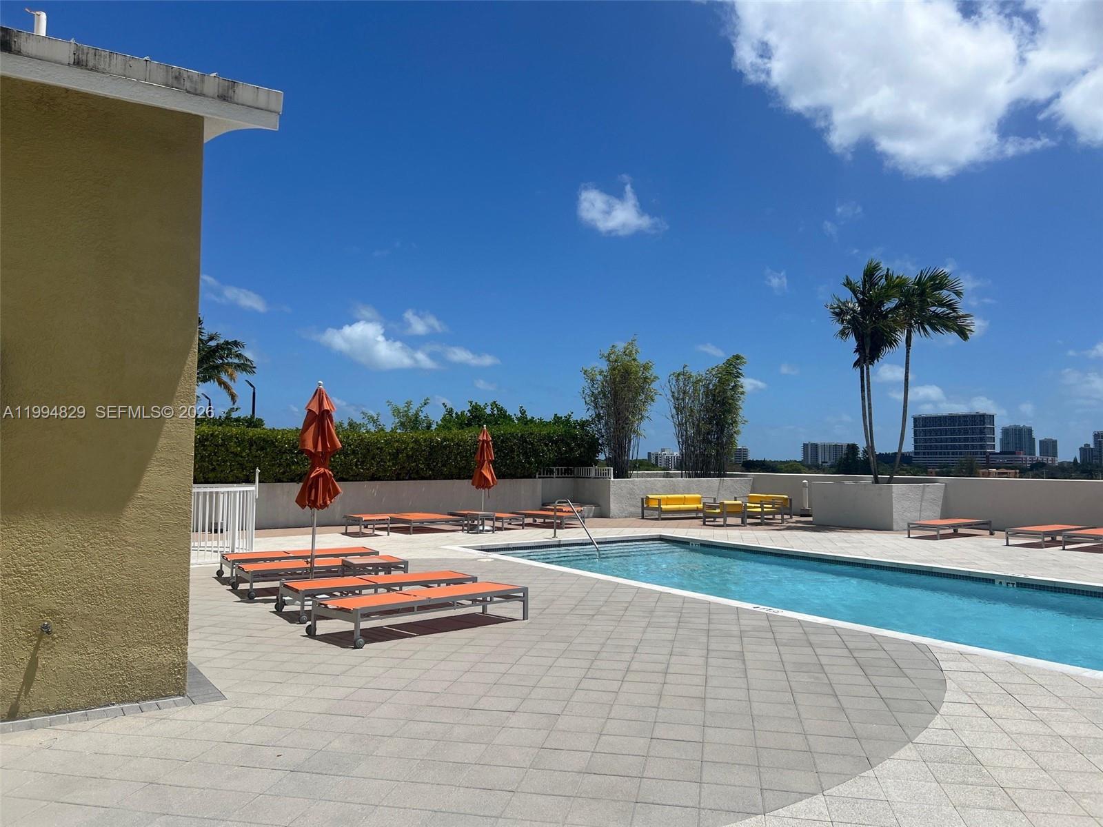 3180 Southwest 22nd Terrace, Unit 607 Miami, FL 33145 - Photo 6 of 18 a view of a swimming pool with lounge chairs