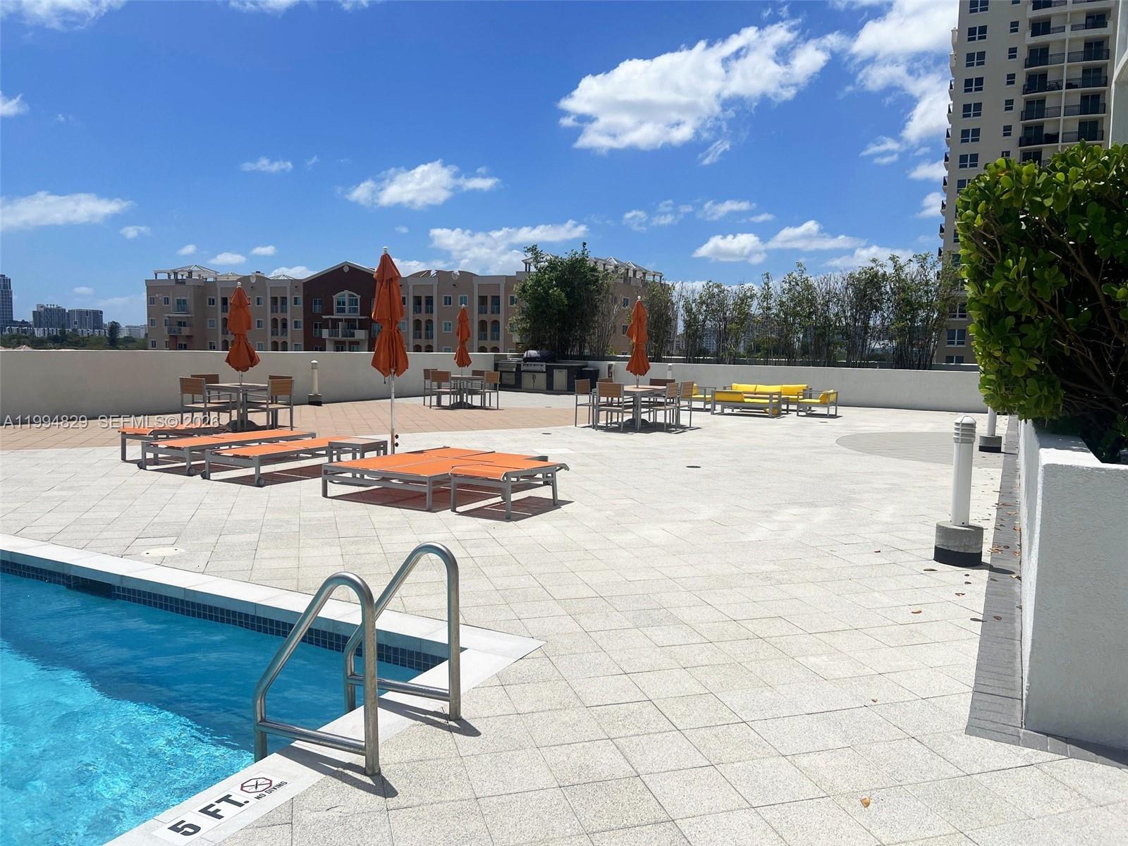 3180 Southwest 22nd Terrace, Unit 607 Miami, FL 33145 - Photo 7 of 18 a swimming pool with outdoor seating and yard