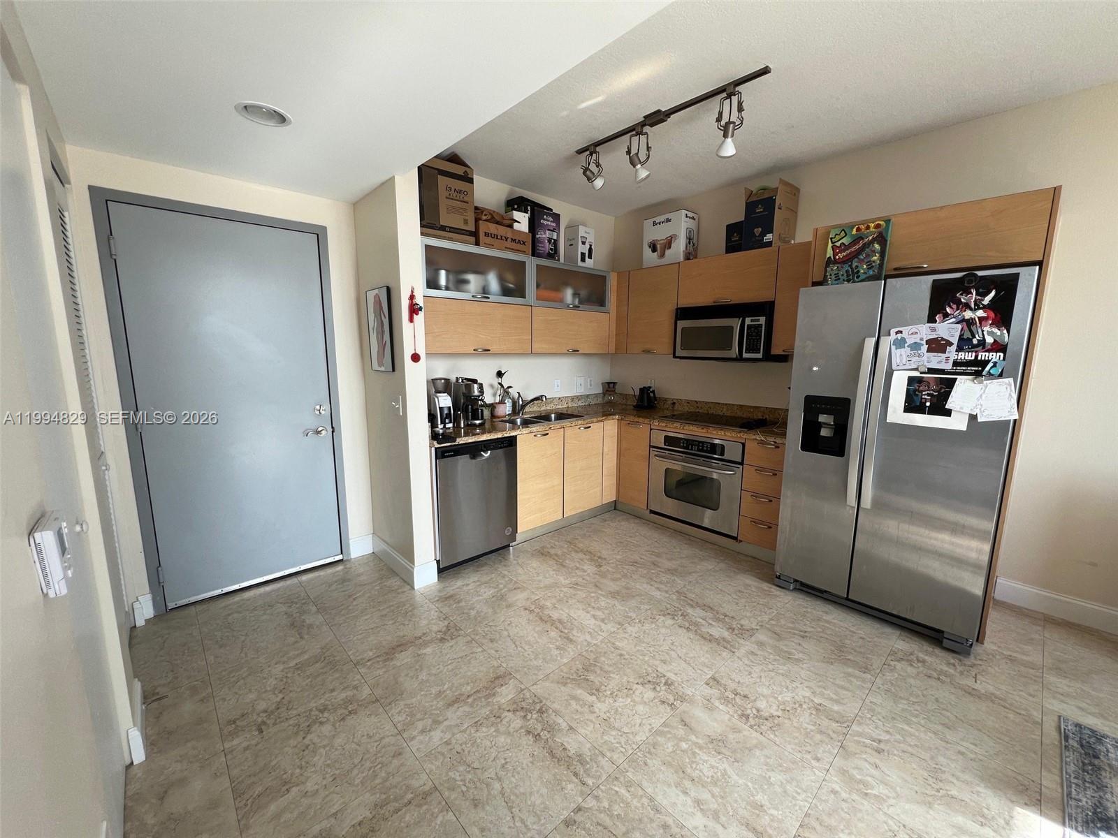 3180 Southwest 22nd Terrace, Unit 607 Miami, FL 33145 - Photo 8 of 18 a kitchen with stainless steel appliances granite countertop a refrigerator and a stove