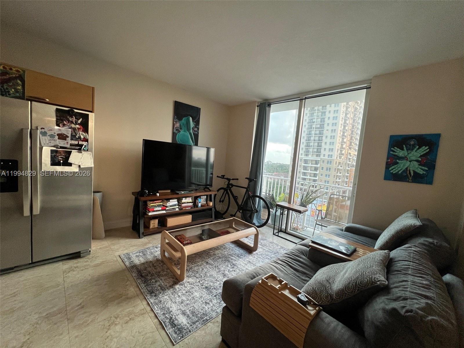 3180 Southwest 22nd Terrace, Unit 607 Miami, FL 33145 - Photo 9 of 18 a living room with furniture and a flat screen tv