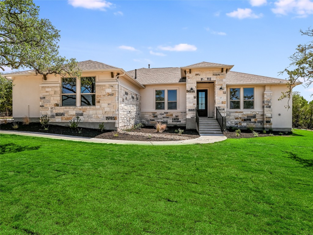 a front view of a house with a garden