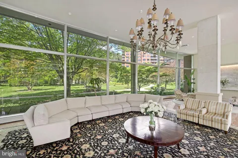 a living room with patio furniture and a large window