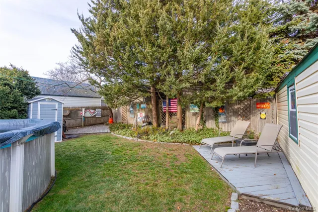 a view of a house with a yard patio and furniture