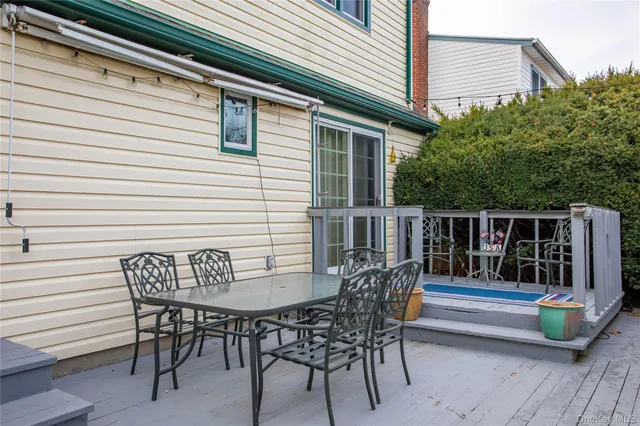 a view of a chairs and table in the balcony