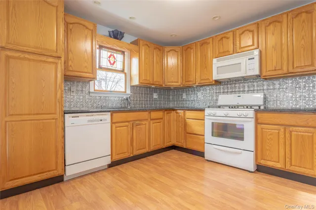 a kitchen with granite countertop cabinets stainless steel appliances and sink