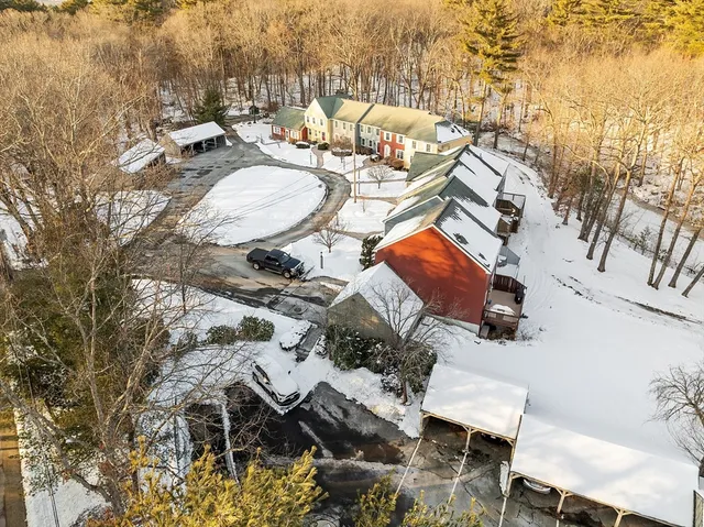 an aerial view of a house with yard and mountain view in back