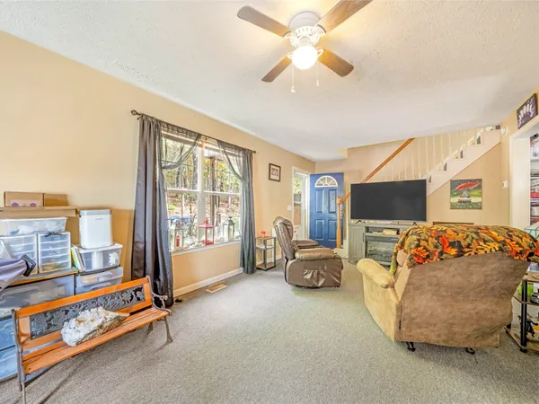 a living room with furniture a flat screen tv and a couch