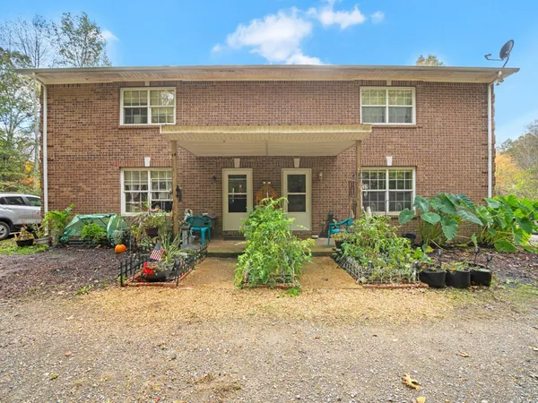 a front view of a house with garden