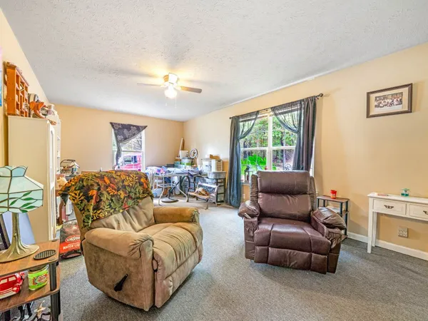 a living room with furniture a fireplace and a window