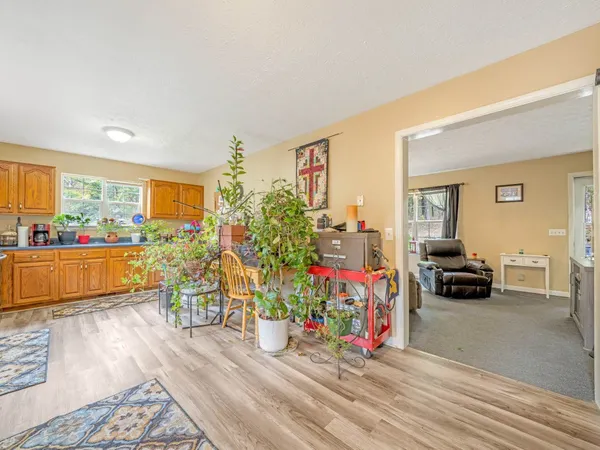 a living room filled with lots of furniture and a wooden floor
