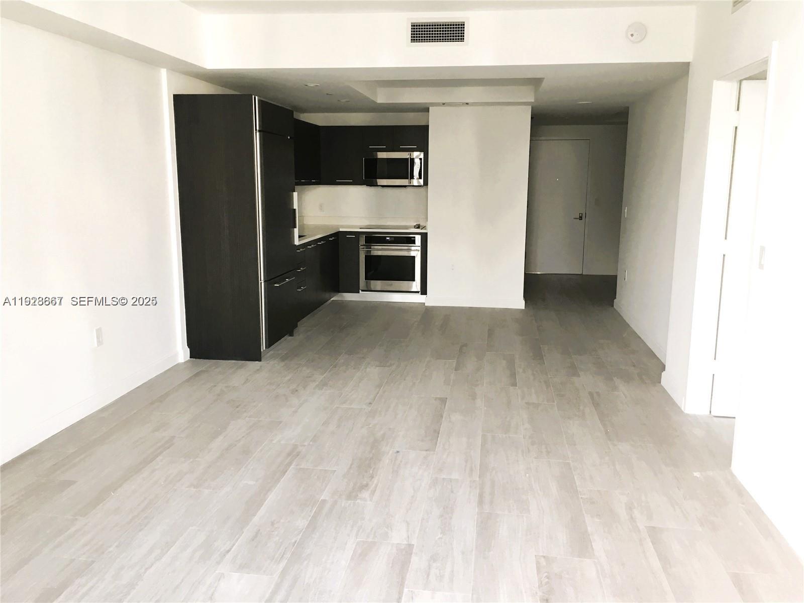 45 Southwest 9th Street, Unit 2805 Miami, FL 33130 - Photo 12 of 16 a view of kitchen and kitchen with furniture