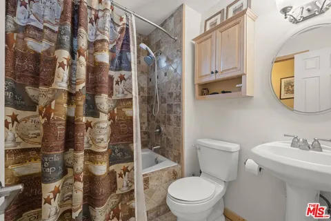 a view of a livingroom with wooden floor and stairs