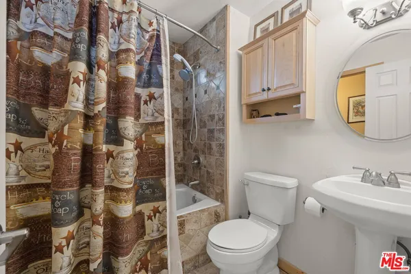 a view of a livingroom with wooden floor and stairs