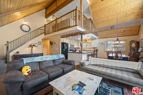 a view of a balcony with wooden floor and outdoor seating