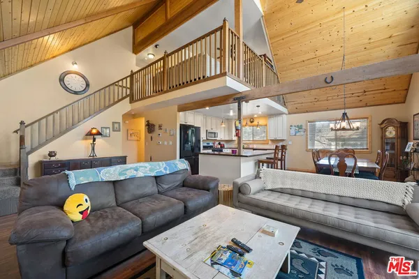 a view of a balcony with wooden floor and outdoor seating