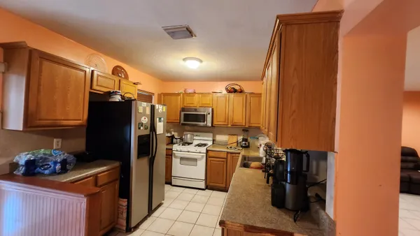 a kitchen with a refrigerator and a stove