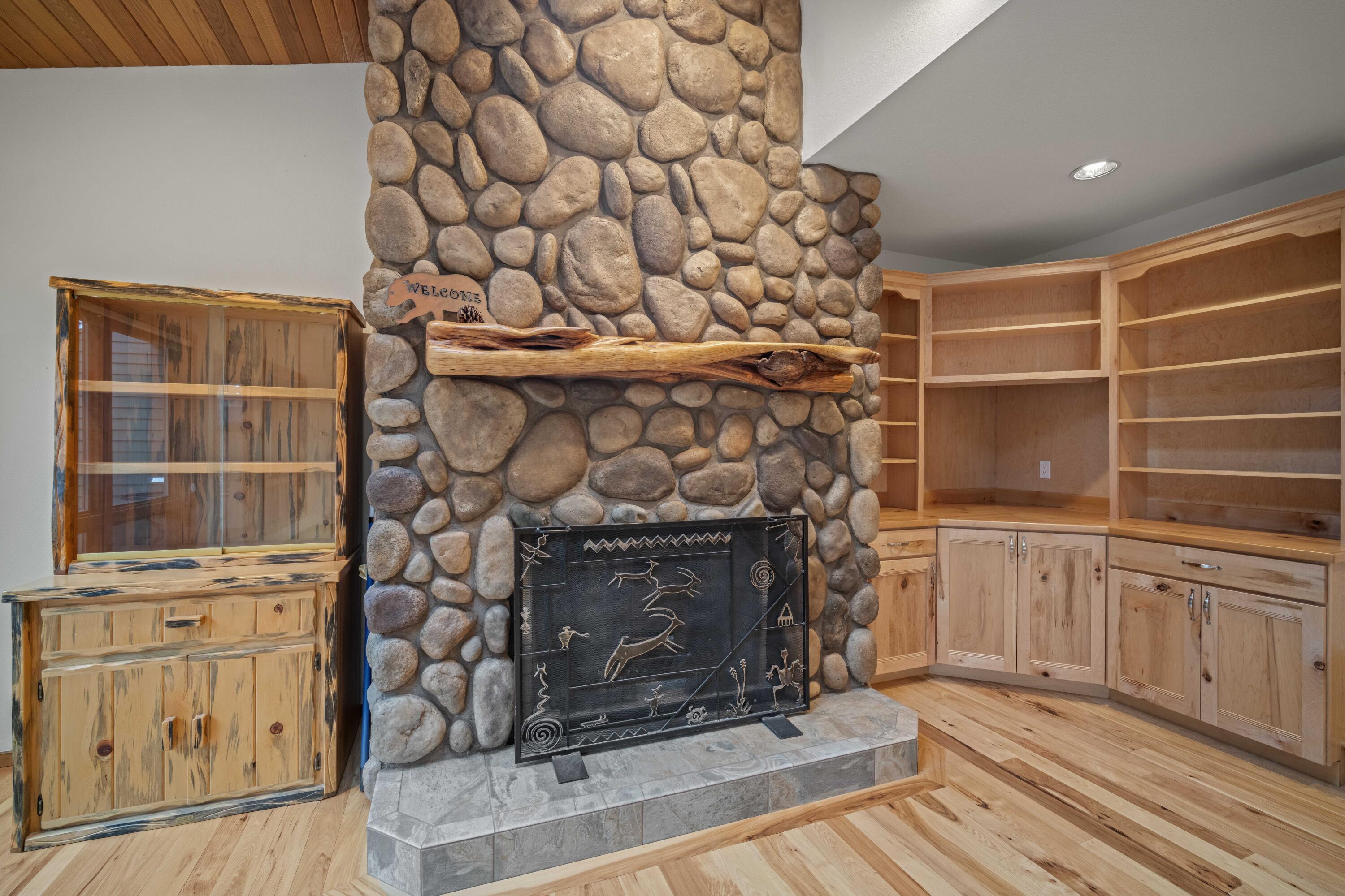 17674 Bittern Lane, Unit 7 Sunriver, OR 97707 - Photo 6 of 43 River-rock fireplace with custom wood mantle anchors the great room.