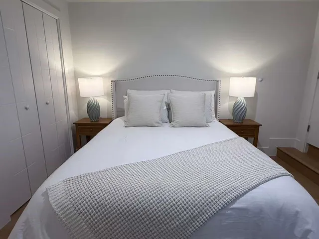 a bedroom with a bed and a mirror