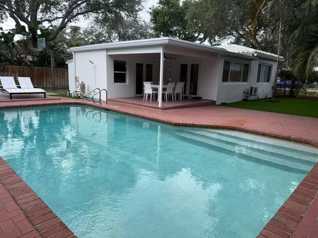 a view of a house with pool yard and swimming pool