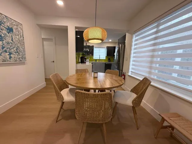a dining room with furniture and wooden floor