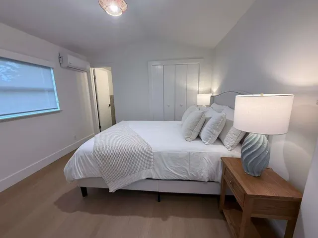 a bedroom with a bed and a lamp