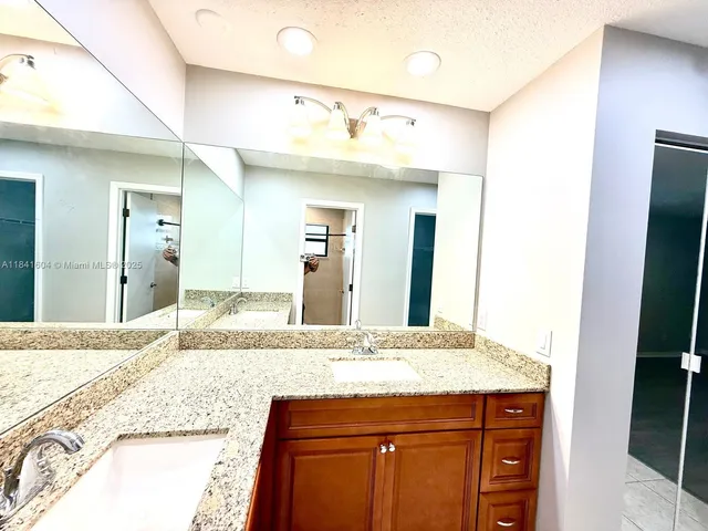 a kitchen with a sink and refrigerator