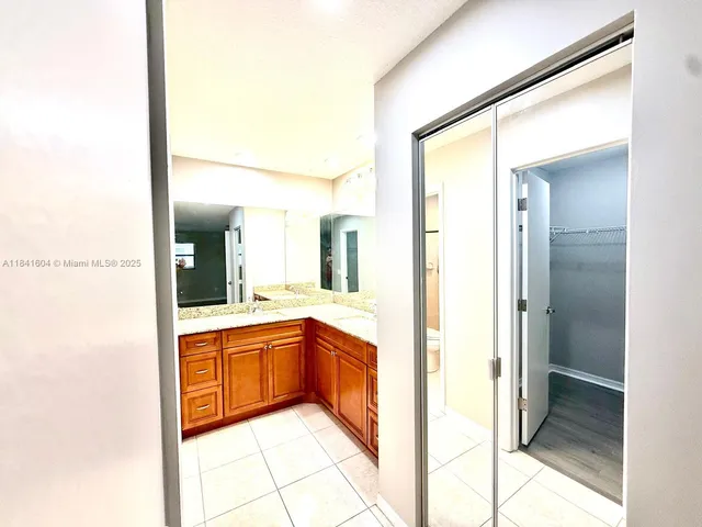 a bathroom with a sink a mirror and a shower