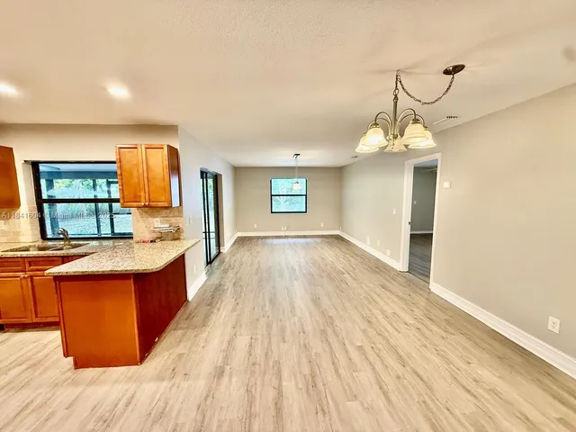 a spacious bathroom with sink a mirror and a bathtub