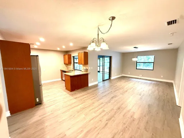 a open kitchen with a sink stove and refrigerator