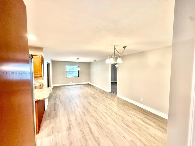a view of a bedroom with a bed and a window