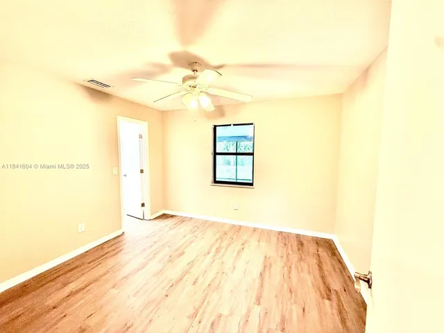 a bathroom with a granite countertop shower and a toilet