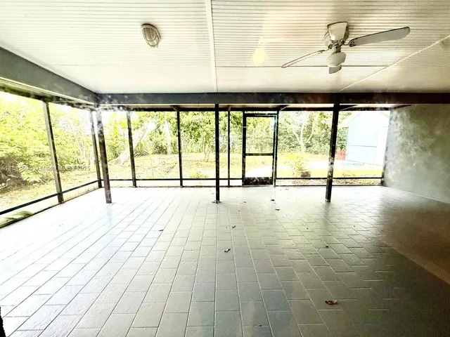 a view of a house with a yard covered in snow