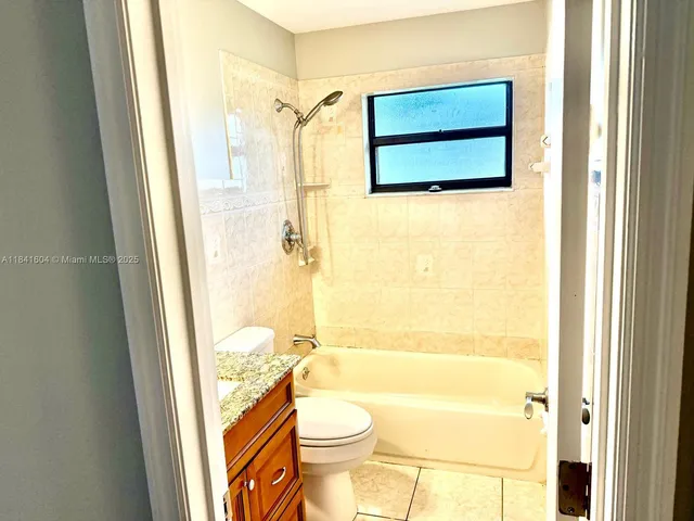 a view of a yard with plants and trees