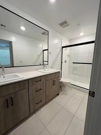 a spacious bathroom with a double vanity sink mirror and double
