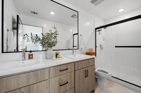 a bathroom with a granite countertop sink toilet and shower
