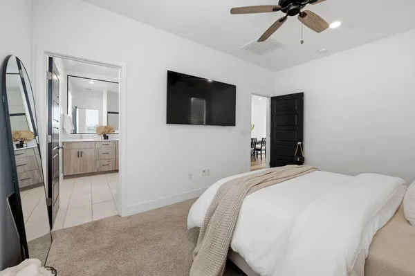 a bedroom with a bed and a flat screen tv