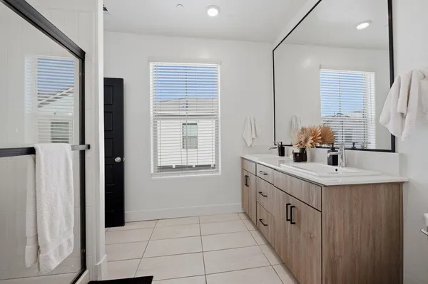 a bathroom with a sink double vanity and a mirror