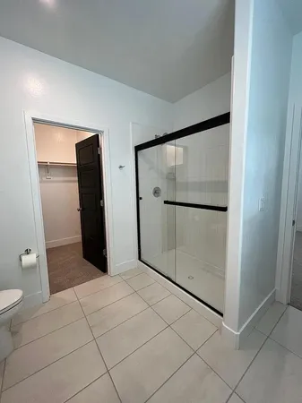 a bathroom with a shower and toilet