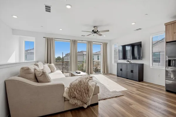 a spacious bedroom with a bed and a large window