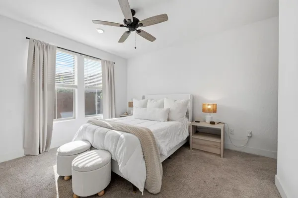 a bedroom with bed and a large window
