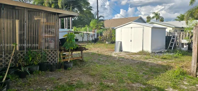 a backyard of a house with plants and outdoor seating
